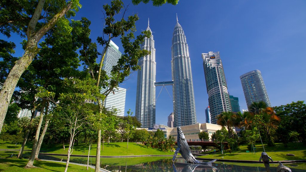 KLCC Park showing a high-rise building, a city and a pond