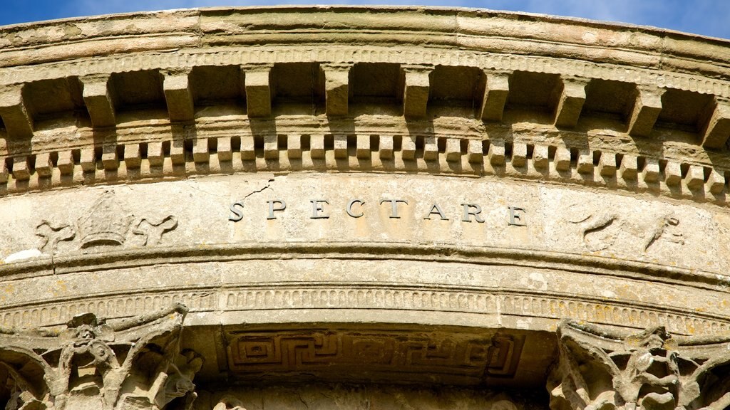 Mussenden Temple showing signage, a temple or place of worship and heritage elements