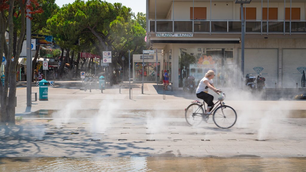 Piazza Mazzini og byder på cykling og et springvand såvel som en kvinde