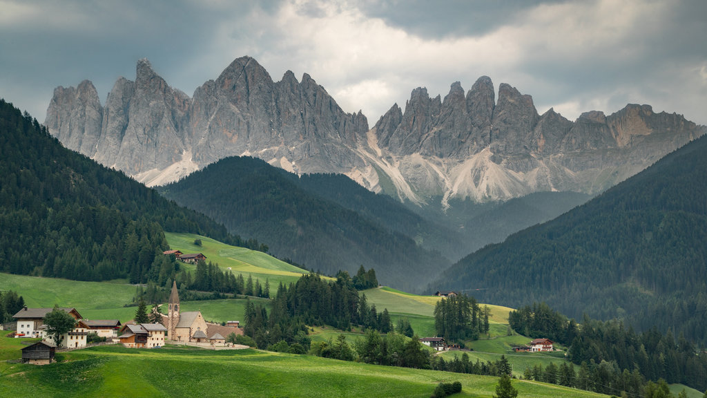 Merano which includes a small town or village, mountains and tranquil scenes