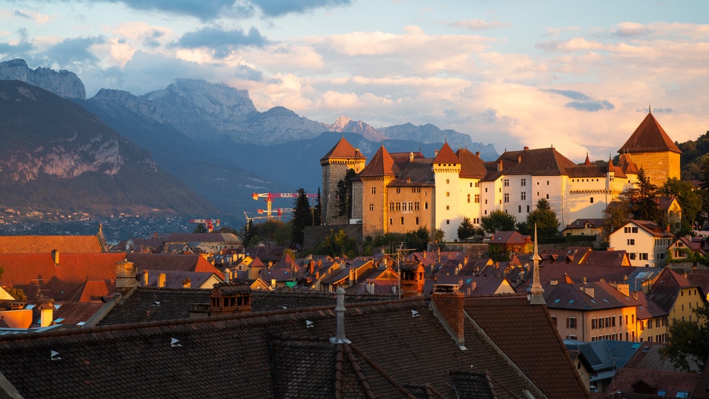 Annecy-le-Vieux featuring a sunset, mountains and a small town or village