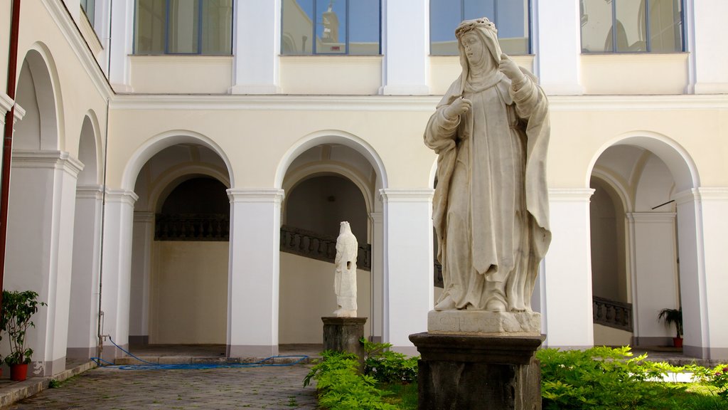 Piazza San Domenico Maggiore showing a square or plaza, religious aspects and a statue or sculpture