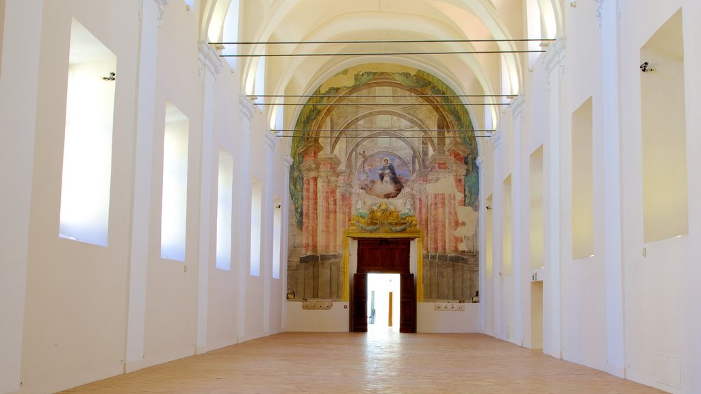 Piazza San Domenico Maggiore que incluye patrimonio de arquitectura, aspectos religiosos y vistas interiores