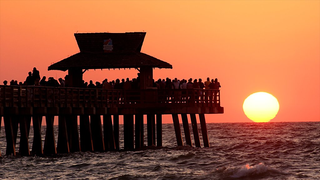 Sanibel Captiva Island showing general coastal views and a sunset as well as a large group of people