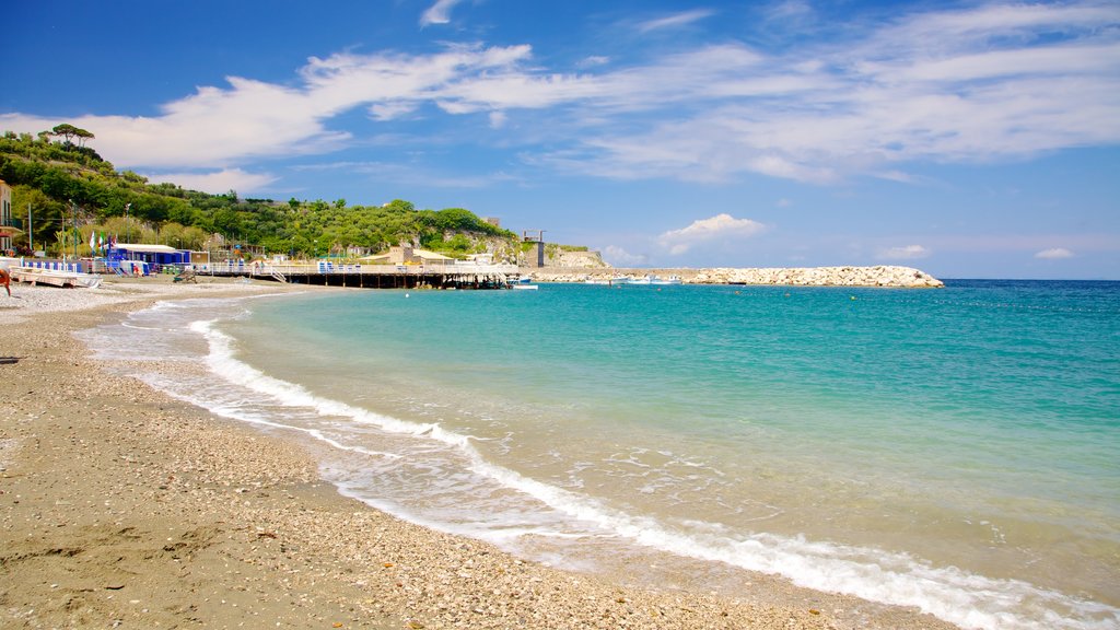 Marina di Puolo ofreciendo una playa de piedras y una bahía o un puerto