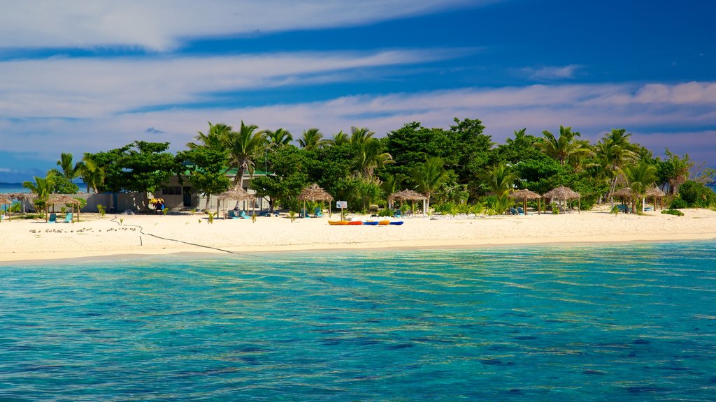 Fiji which includes a coastal town, island views and a sandy beach