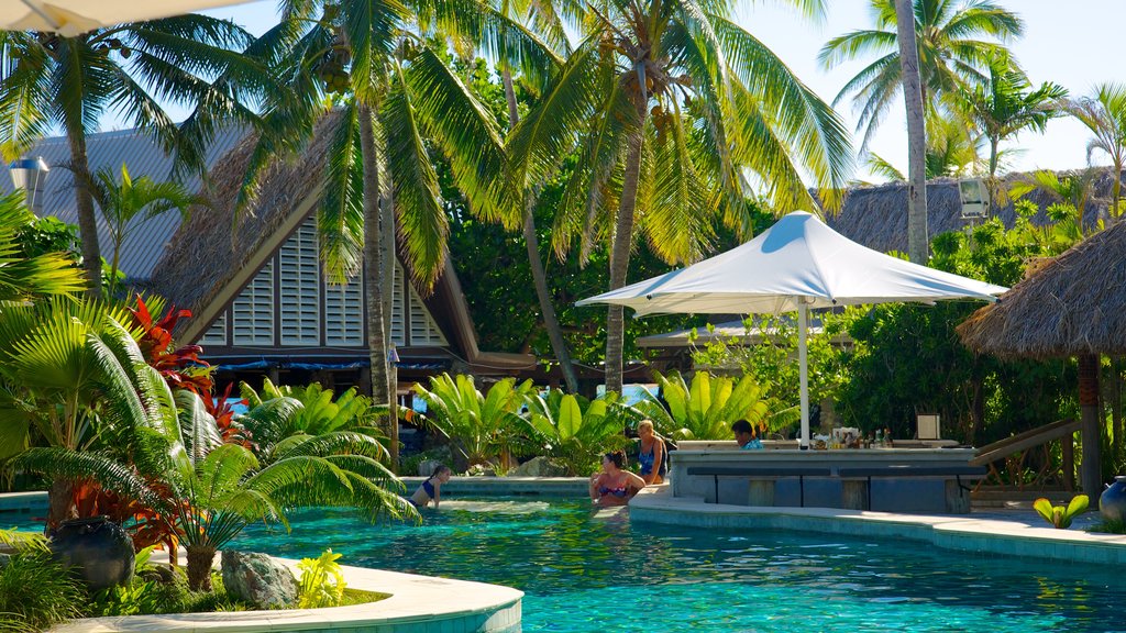 Castaway Island featuring a pool, tropical scenes and a luxury hotel or resort