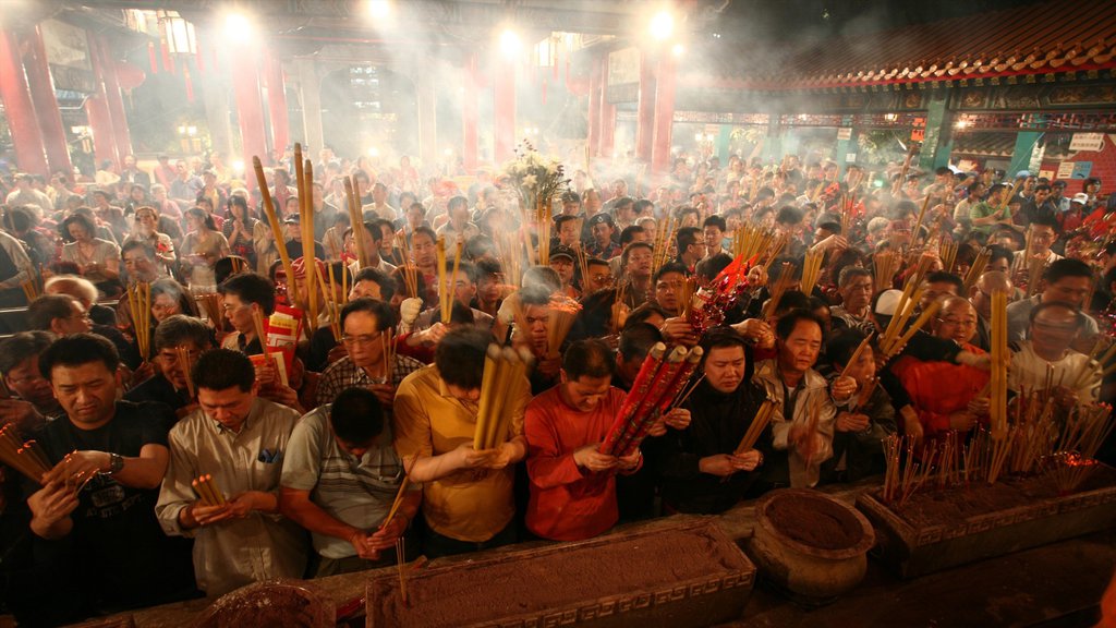 Wong Tai Sin Temple featuring a temple or place of worship, religious elements and interior views