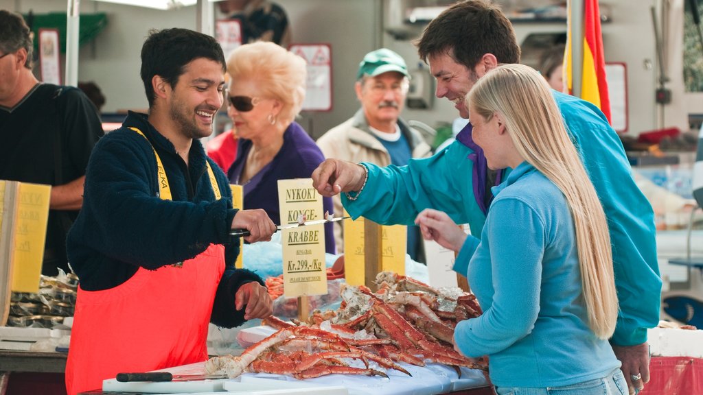 Torget Fishmarket featuring markets and food as well as a small group of people