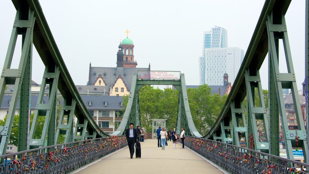 Frankfurt showing a bridge as well as a small group of people