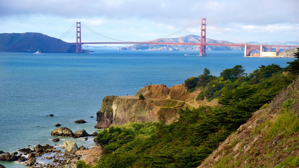 Coastal Trail featuring a bridge, rugged coastline and a river or creek