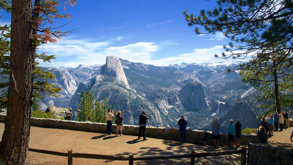 Washburn Point featuring mountains and views as well as a small group of people