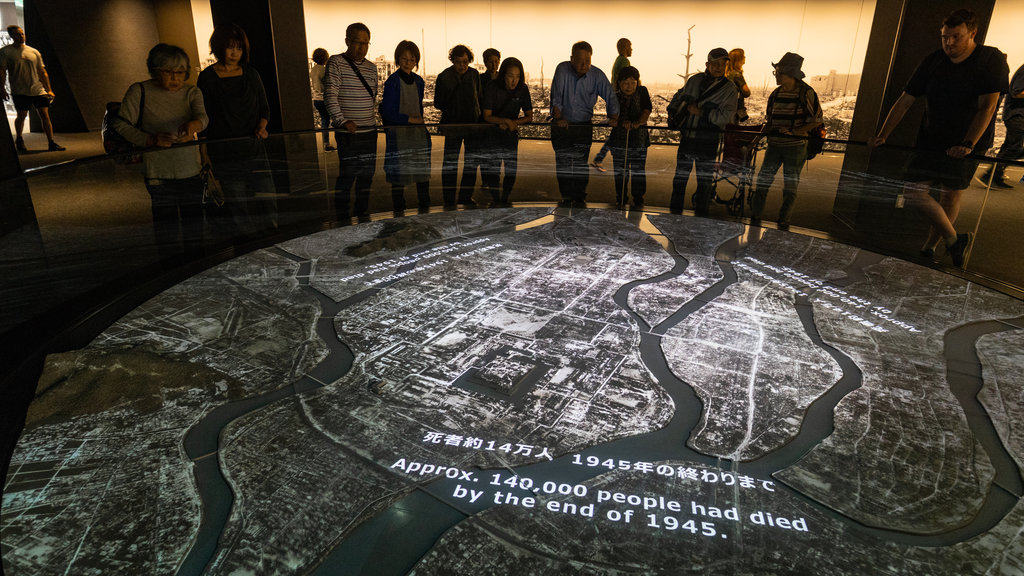 Hiroshima Peace Memorial Museum showing interior views as well as a small group of people