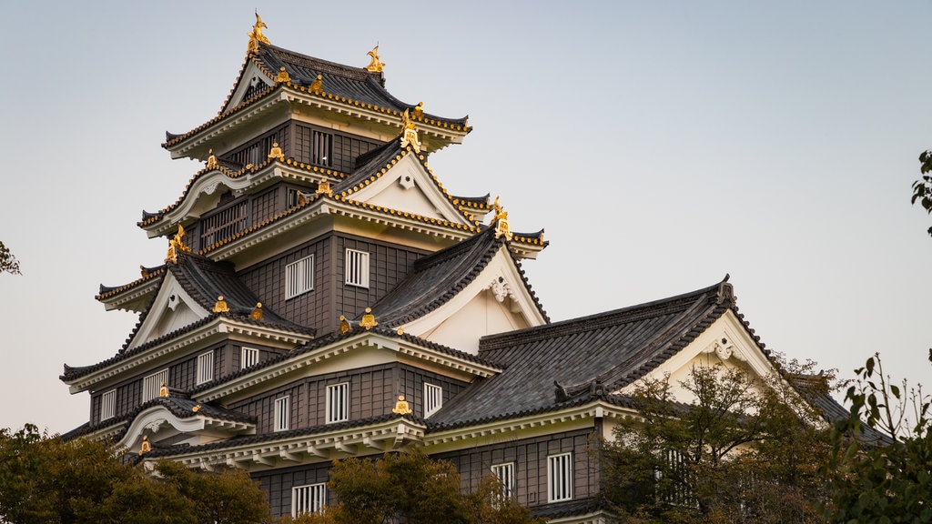 Okayama Castle featuring heritage architecture and a sunset