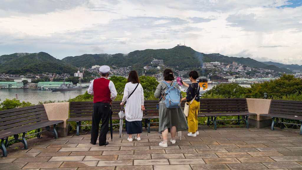 Glover Garden which includes a river or creek and views as well as a small group of people