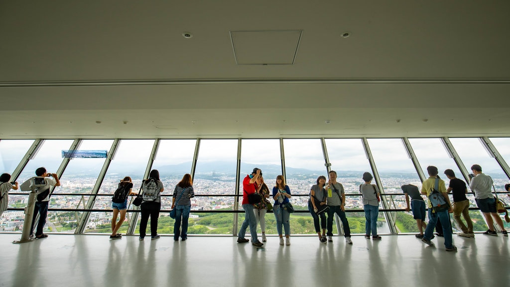 Goryokaku Tower featuring views and interior views as well as a small group of people