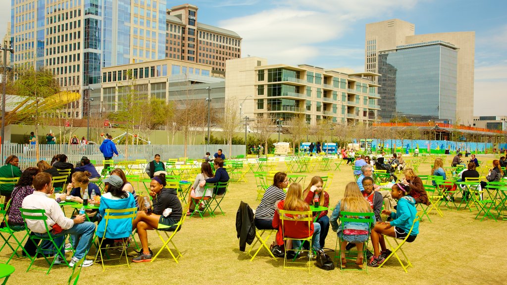 Klyde Warren Park which includes outdoor eating, a city and a garden