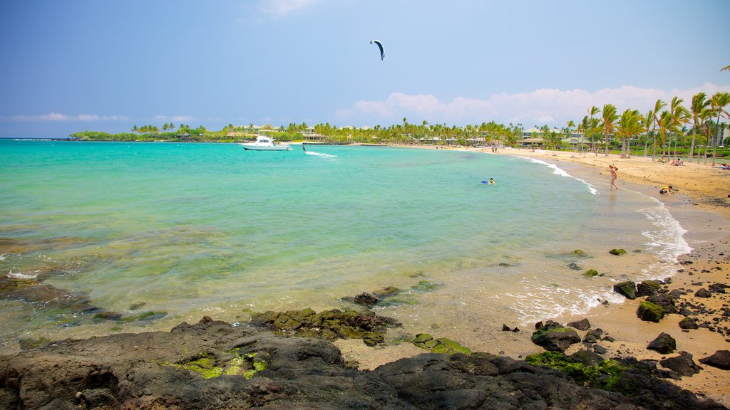 Hawaii showing boating, kite surfing and a pebble beach