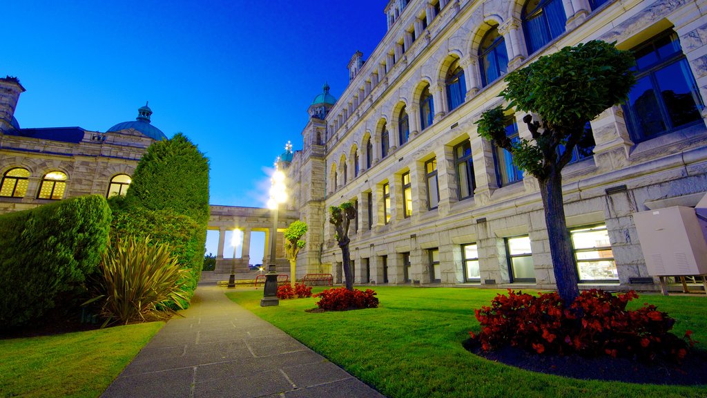 British Columbia Parliament Building showing a sunset, a park and flowers