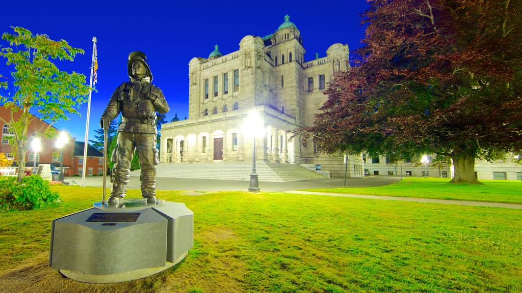 British Columbia Parliament Building showing an administrative buidling, night scenes and a statue or sculpture