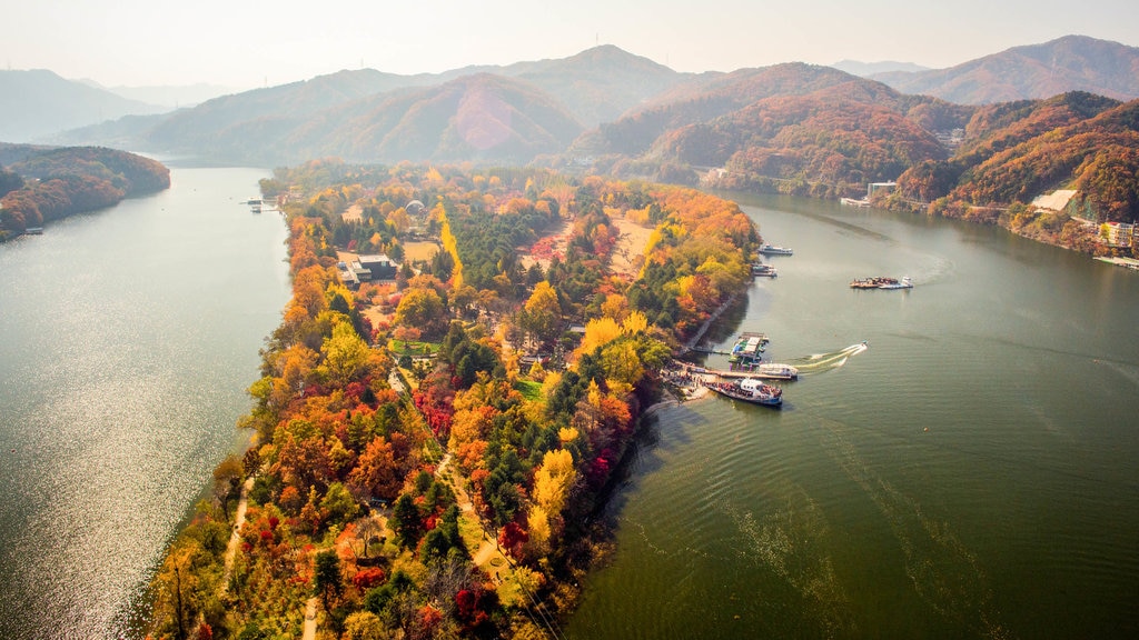 Nami Island which includes landscape views, tranquil scenes and a river or creek