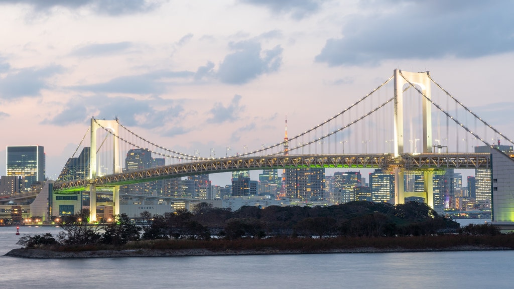 Rainbow Bridge which includes a city, a river or creek and a sunset