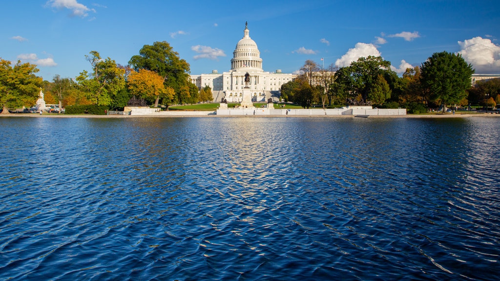 United States Capitol showing a lake or waterhole, heritage architecture and an administrative buidling