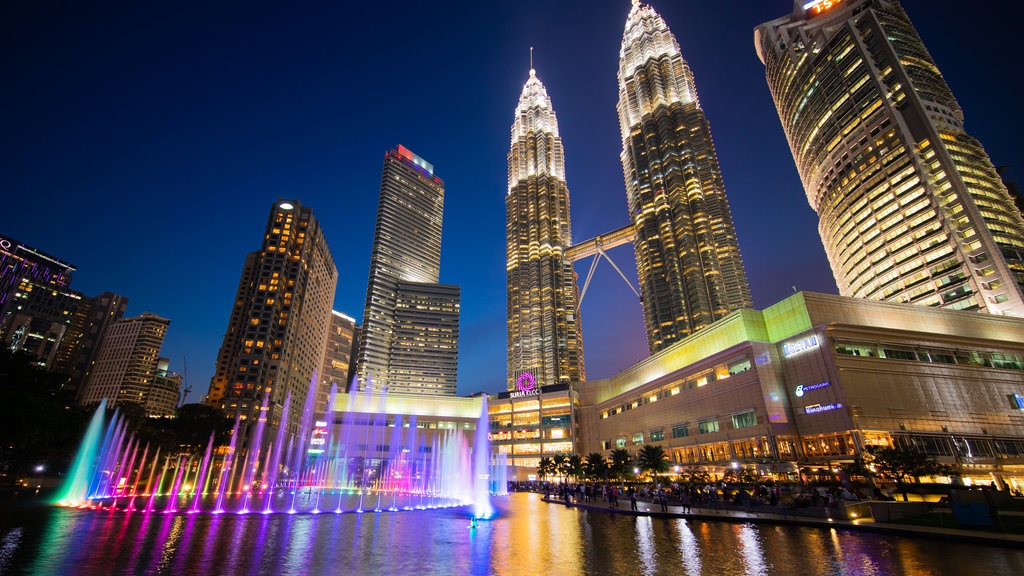 KLCC Park which includes a high-rise building, night scenes and a fountain