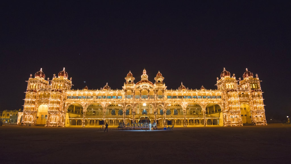 Mysore Palace which includes a castle, heritage architecture and night scenes