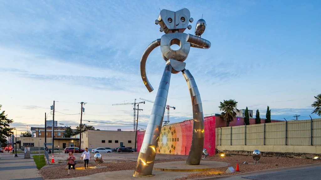 Deep Ellum which includes outdoor art and a sunset