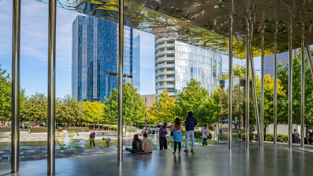 Klyde Warren Park showing a city as well as a small group of people