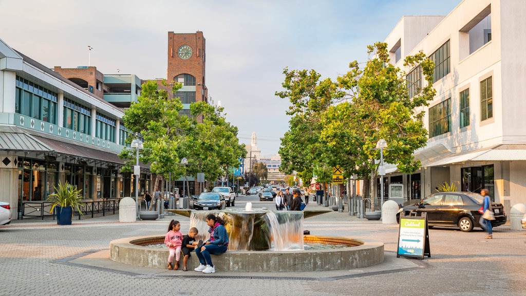 Jack London Square featuring a fountain as well as a family