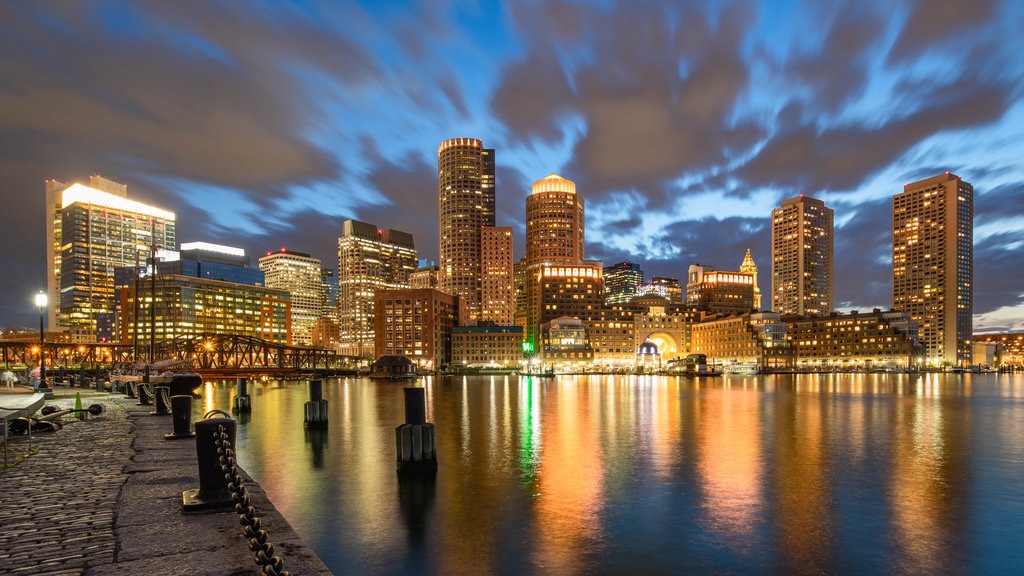 Seaport District which includes night scenes, a city and a bay or harbour