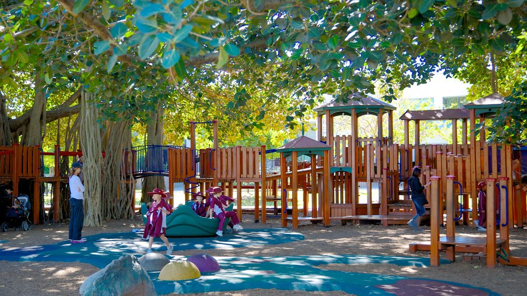 New Farm Park showing a playground and a garden as well as children