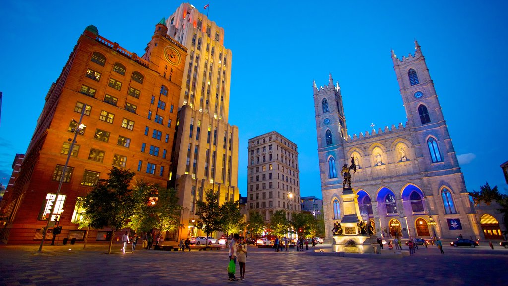 Notre Dame Basilica which includes a square or plaza, a city and heritage architecture