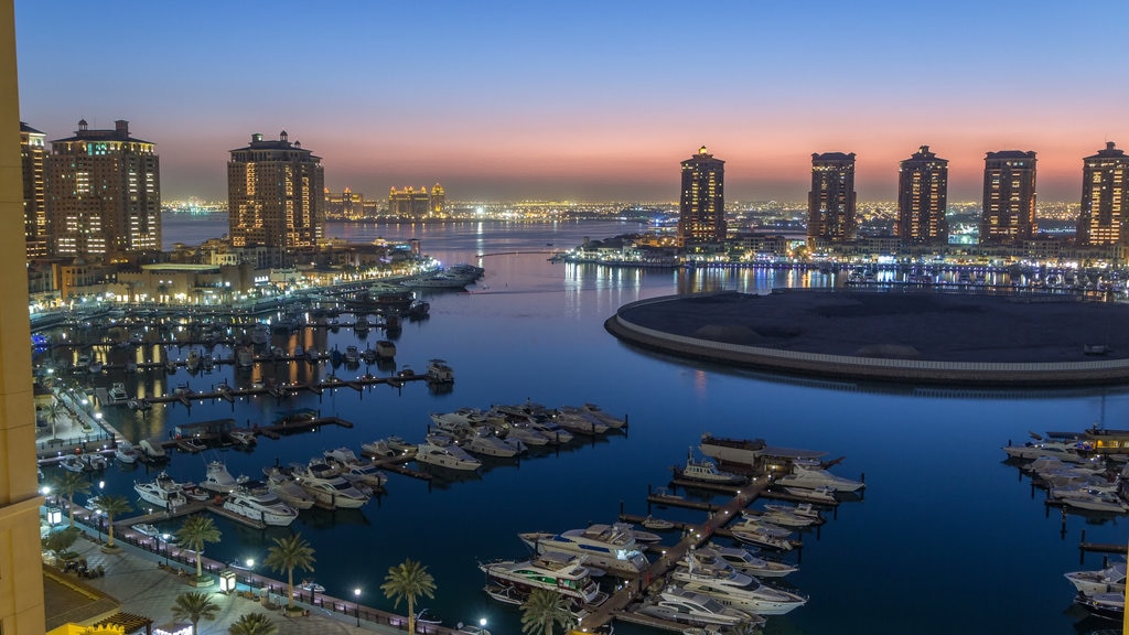 The Pearl-Qatar which includes landscape views, a sunset and a city