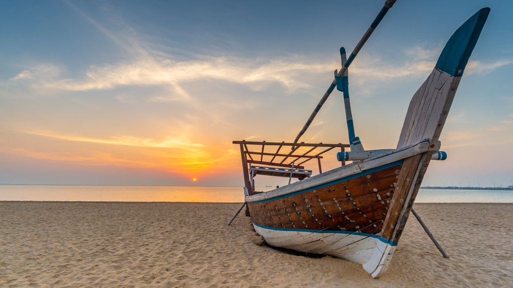 Al Wakrah Beach featuring a beach, a sunset and heritage elements