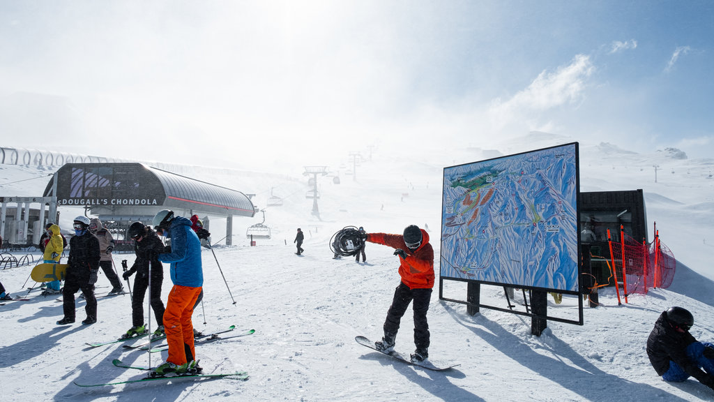 Cardrona Alpine Resort featuring snow and snow skiing as well as a small group of people