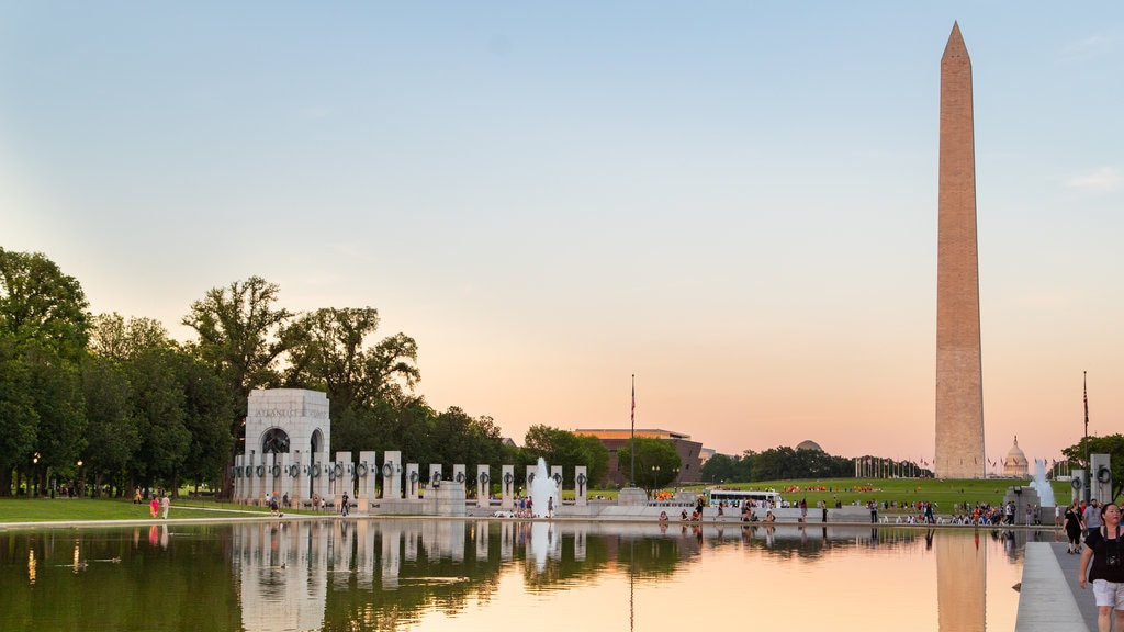 National World War II Memorial which includes a sunset, a lake or waterhole and a monument