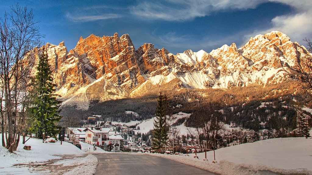 Eastern Dolomites showing mountains, a small town or village and snow