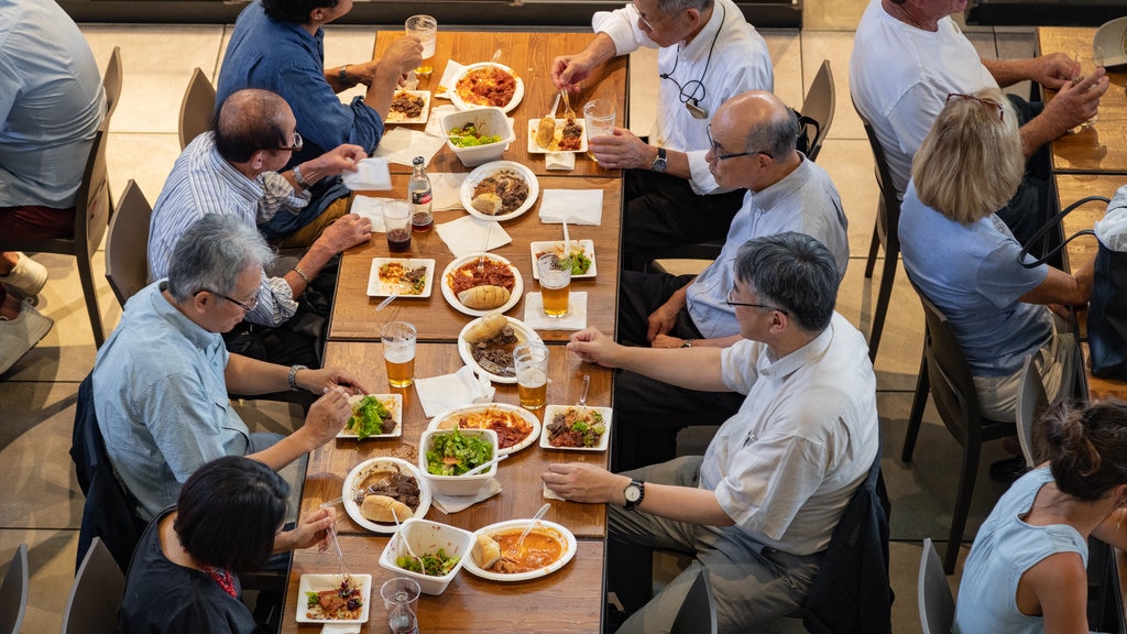 Central Market showing dining out as well as a small group of people