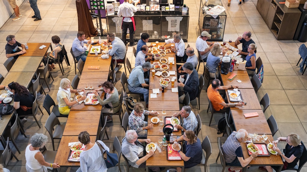 Central Market which includes dining out and interior views as well as a large group of people