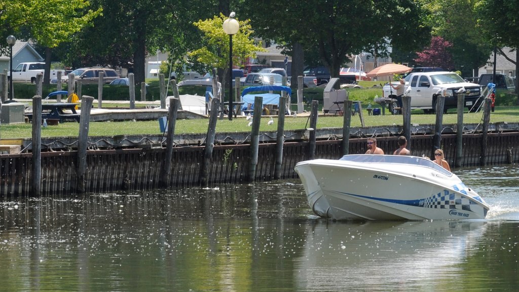 Chatham-Kent featuring boating and a bay or harbor as well as a small group of people