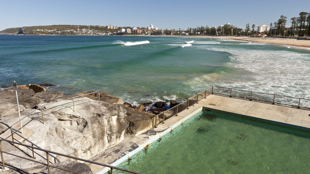 Manly Beach showing a coastal town, a sandy beach and a pool