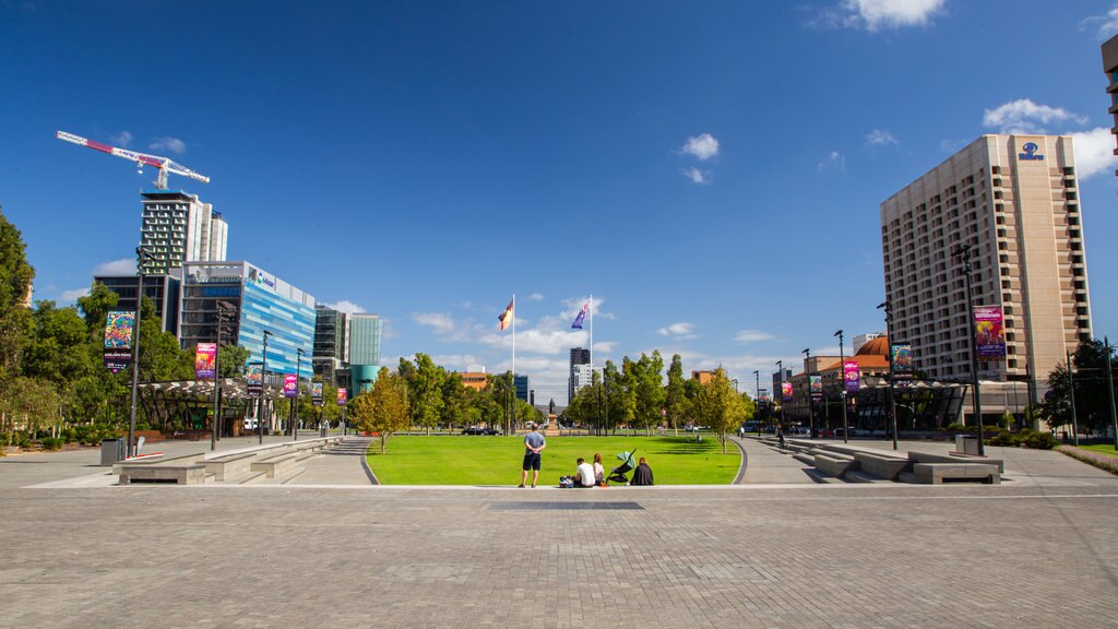 Victoria Square showing a garden as well as a small group of people