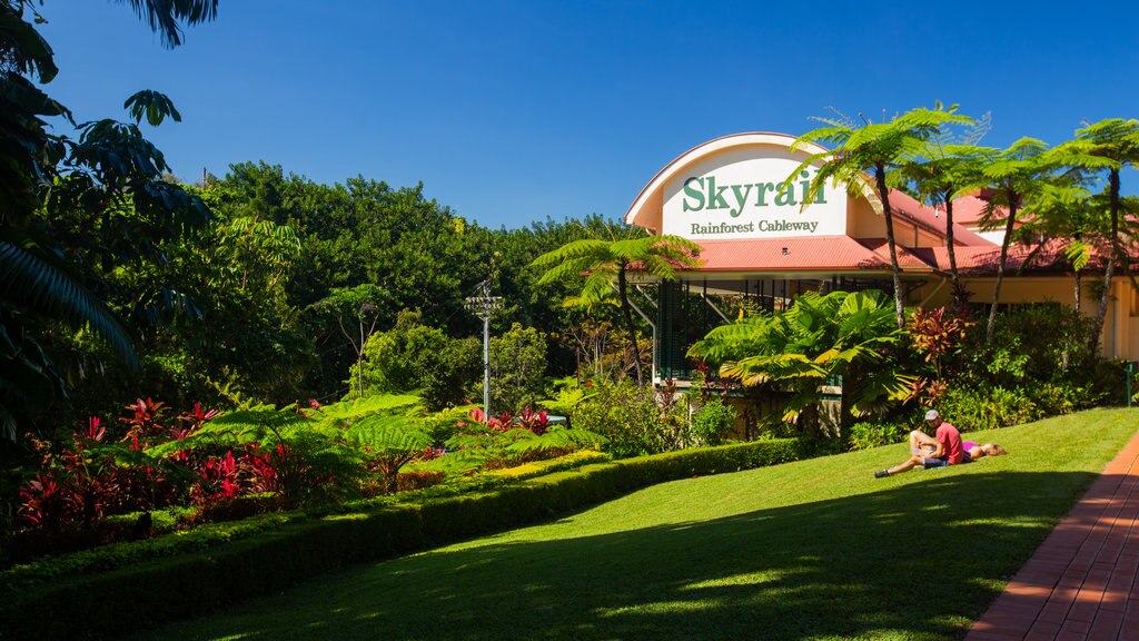 Kuranda showing a garden and signage as well as a couple