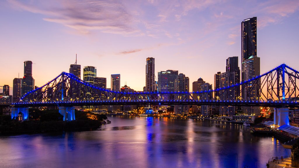 Story Bridge which includes a river or creek, a city and a sunset