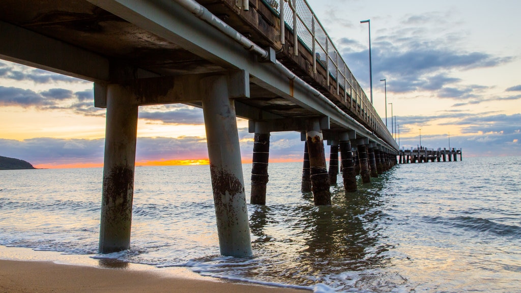 Palm Cove Beach showing general coastal views, a sandy beach and a sunset