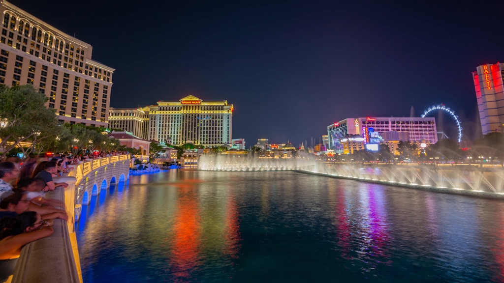 Bellagio Casino featuring a lake or waterhole, a fountain and a city