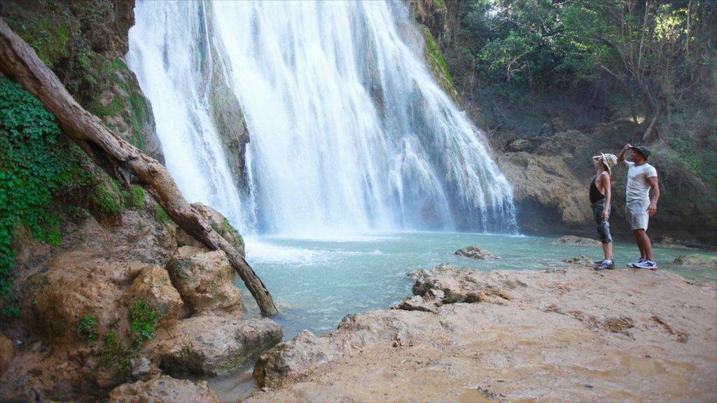 El Limon Falls showing hiking or walking and a waterfall as well as a couple